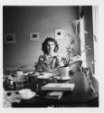 [Nancy Newhall seated across table]