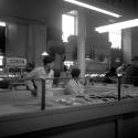 [Two fishmongers standing behind display]