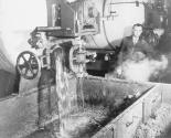 Conservation: Rendering of Household Fats. Reclaimed household greases from America's kitchens drain into an open vat at a rendering plant. Some of the batches are recooked with additional fats to bring them up to certain specific grades.
