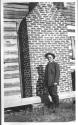 George Eastman beside chimney and addition construction, Oak Lodge Trip
