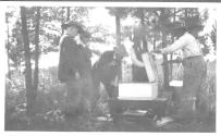 George Eastman and guests inspecting bee boxes, Oak Lodge Trip