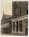 [Commercial storefronts with sign for "Quick Shoe Repairing"]