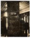 [Building interior with sign on marble column]