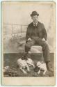 [Young man in studio with two hound dogs]