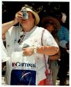 [Group of cruise ship tourists on land, woman taking a photo with point and shoot digital camera.]
