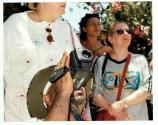 [Group of cruise ship tourists on land, man with video camera pointed upwards, shooting view]