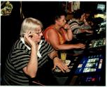 [Three women at slot machines]