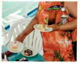[Close up of woman with three small plates of cake, bottle of diet Coke and plastic glass]