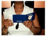 [Close-up detail of woman with decorative finger nails holding ship directory booklet]
