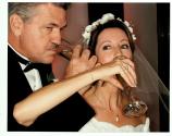 [Groom and bride linking arms and taking a drink from a glass]