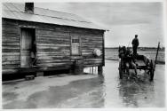 African American farmers, young woman in doorway