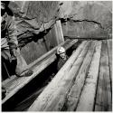 Ralph Schmidt and the late Guy Bruneau timbering a staging for drilling a breast in a shrinkage stope, 1300 foot level, Kerr Mine, Virginiatown, Ontario, Canada
