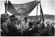 Israel, wedding where the traditional tent, or "huppah," poles are improvised from guns and pitchforks.