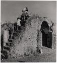 [Cisterna Italy, children climbing up steps on side of ruined house]