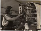 [Woman assembling section of an aircraft in factory]