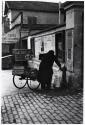 [Woman at water pump in Paris square]