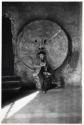 [Rome, boy seated in front of the marble mask known as "Bocca della Verita"]