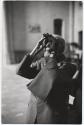 [Art connoisseur Bernard Berenson on his 90th birthday, in Borghese Gallery, Rome, looking through small binoculars]
