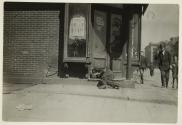 [Man sleeping in doorway]