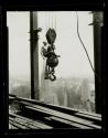 [Man on hoisting ball, Empire State Building]