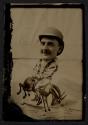 [Caricature of man riding bucking horse backwards]