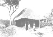 Mrs. Johnson Chatting in front of Hut