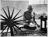 [Mahatma Gandhi, April 1946, with his charka, or spinning wheel, symbol of India's struggle for independence.]