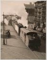 [Freight train in city]