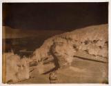 [Landscape with town, road near river or lake]