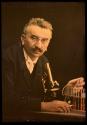 [Louis Lumiere with microscope and test tubes]