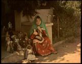 [Girl with collection of dolls]