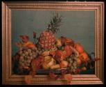 [Still life study, bowl of fruit behind gold frame]