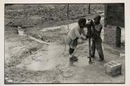 [Two children at water pump]