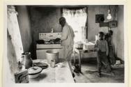 [Man and two boys in kitchen]