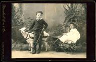 [Two children with goat-drawn cart]