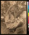 [Girl with goat in her lap]