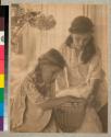 [Two girls looking at a bowl]