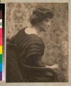 [Seated woman with hair pinned up]