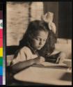 [Young girl writing]
