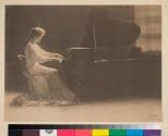 [Woman playing piano]