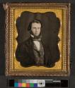 [Man with beard, wearing a suit]