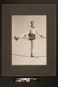[Aerialist William Witaschek, "The Great Calvert" balancing on one foot on the high wire]