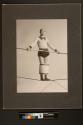 [Aerialist William Witaschek, "The Great Calvert" balancing with legs in a barrel on the high wire]