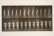 Descending stairs, hands clasped