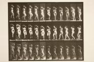 Descending stairs, turning, water jar on r. shoulder