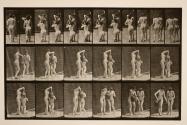 Two models, 8 kneels, drinks from water-jar in hands of 1, and both walk off