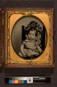 [Portrait of child seated in gothic chair]
