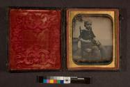 [Portrait of young boy seated in posing chair]