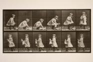 Child; lifting a doll, turning, and walking off