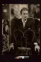 [Man sitting on chair]